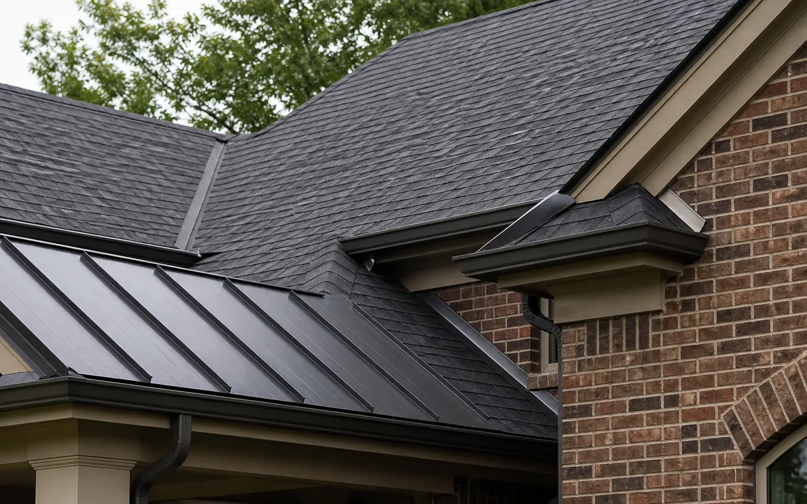 Asphalt shingles and standing-seam metal roof detail on an Indianapolis home
